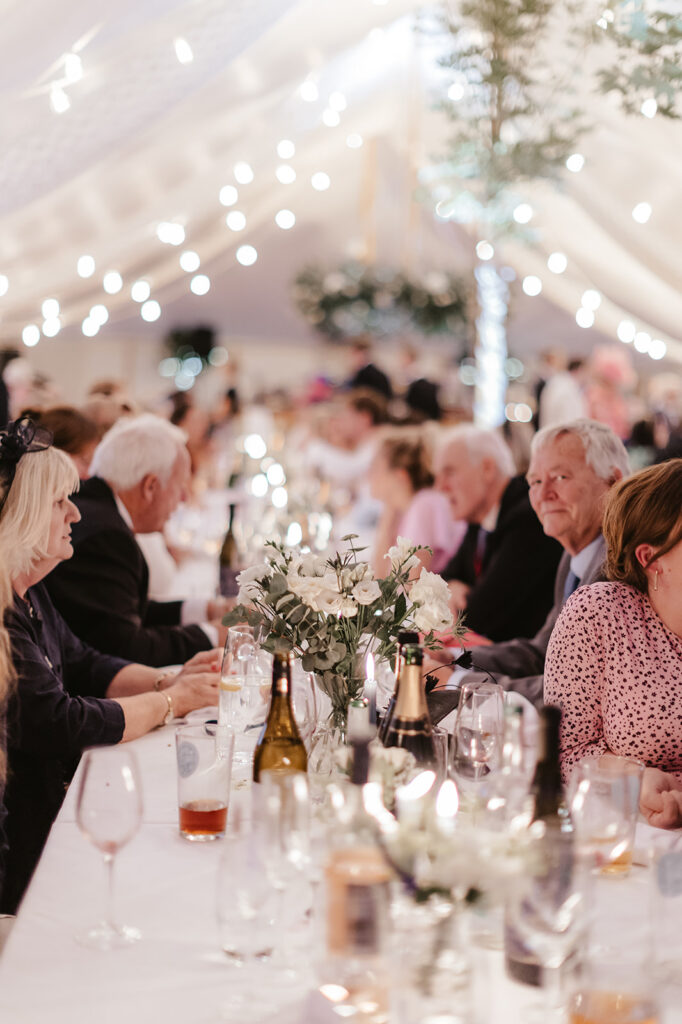 Guests enjoying the evening festivities at a private marquee wedding