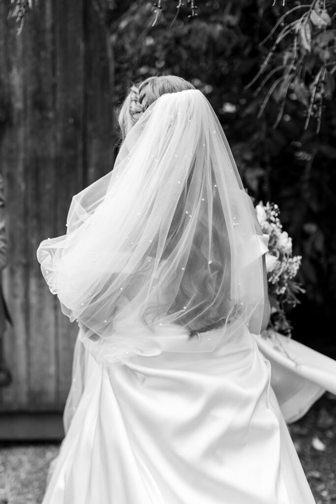 Brides veil and dress details at a wedding venue in Norfolk