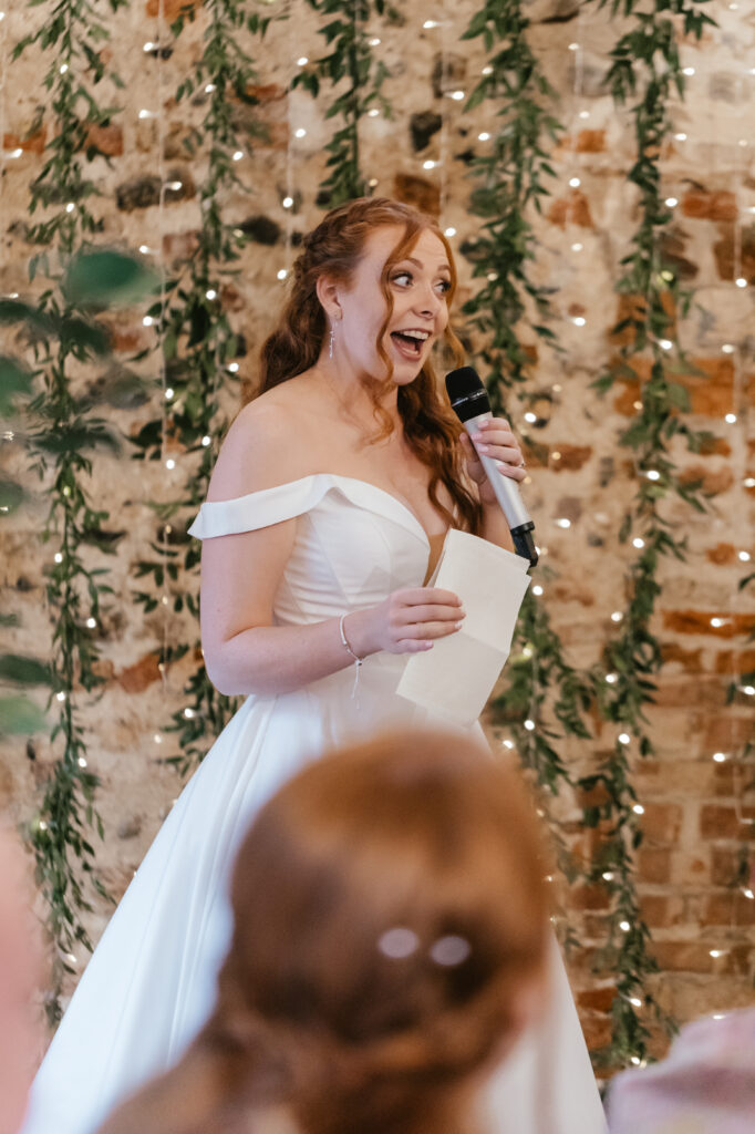 Candid shots for their wedding photo album during wedding speeches