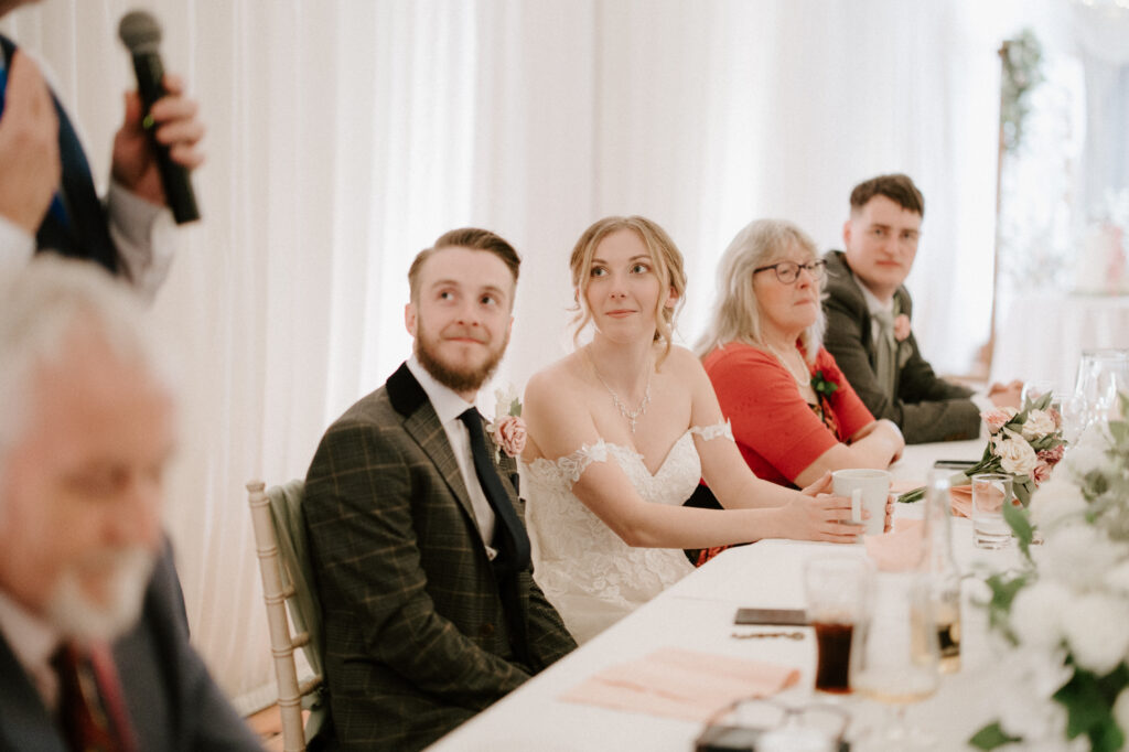 Guests smiling reactions during wedding speeches at a Suffolk wedding venue 